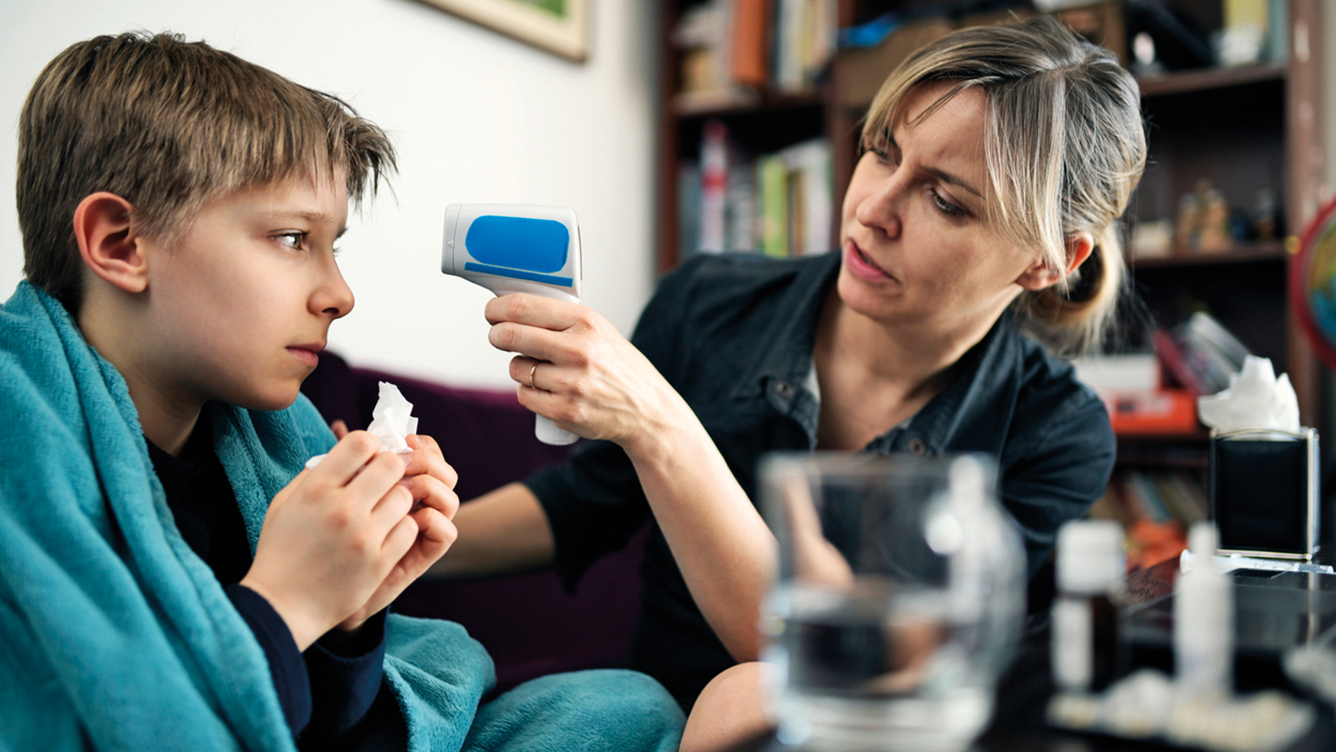 mum checking sons temperature_s.jpg